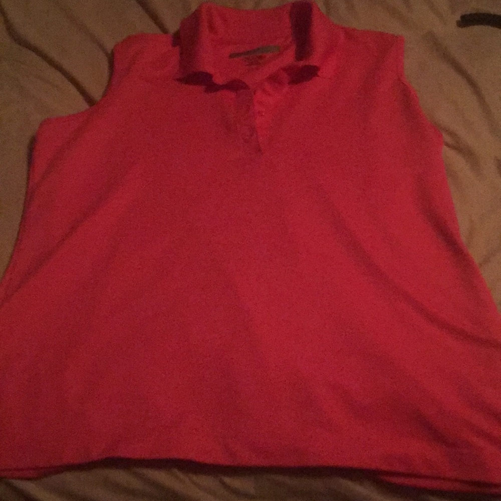 Woman’s coral color Greg Norman golf shirt